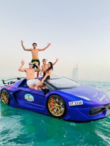 JetCar speeding across the waters of Dubai, with Burj Al Arab