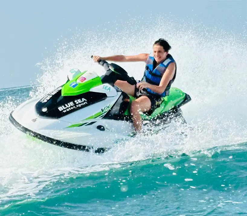 Jet skier riding a high-performance jet ski across Dubai's turquoise waters