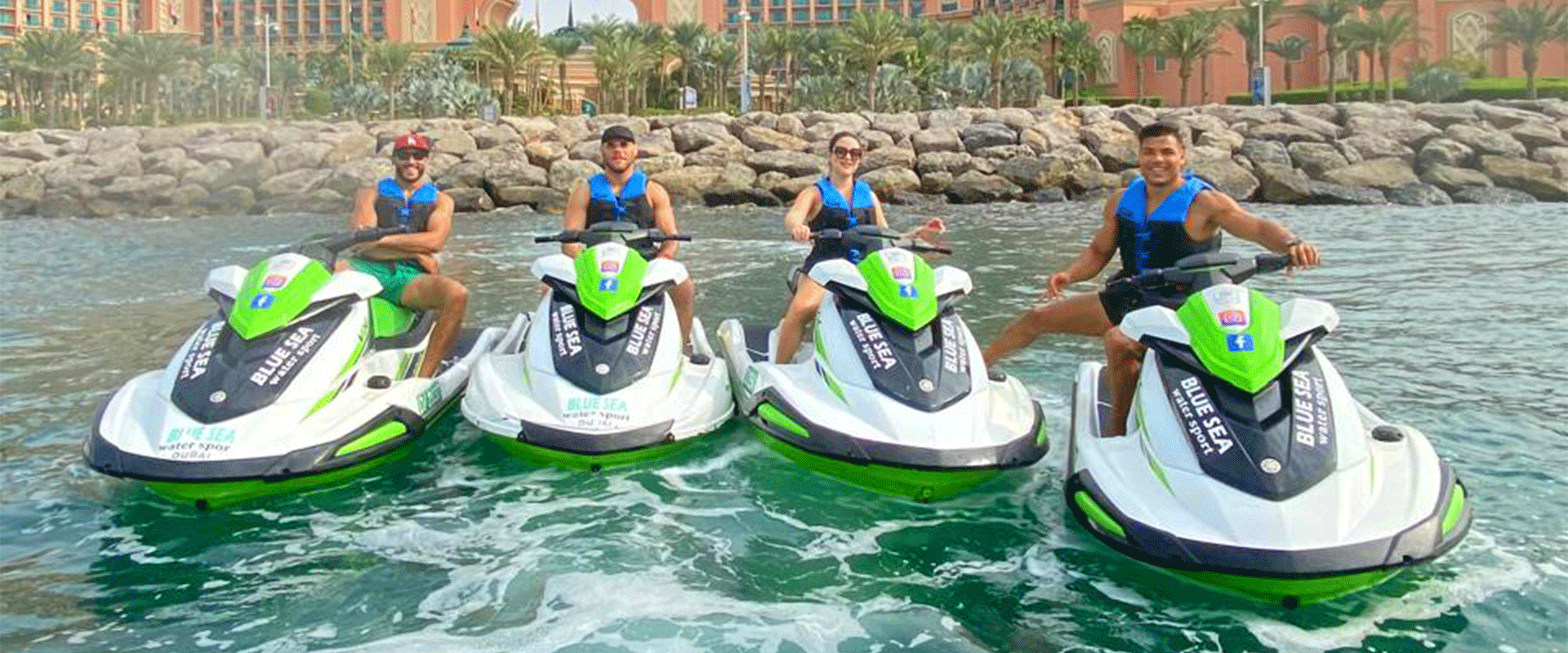 Rider on a jet ski speeding through the turquoise waters of Dubai, with iconic Burj Khalifa