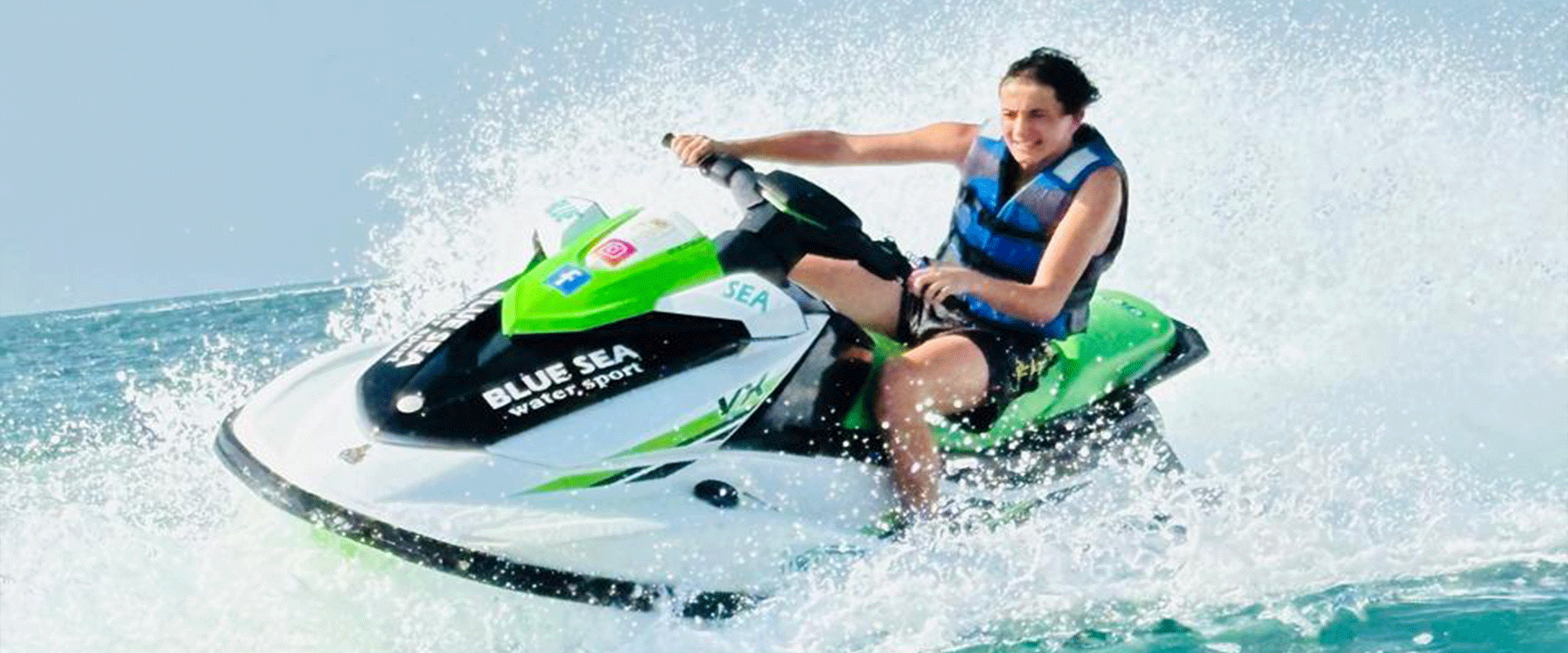 Rider zooming across the clear blue waters of Dubai on a jet ski